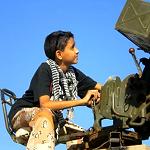 Boy with a video camera in the heart of conflict